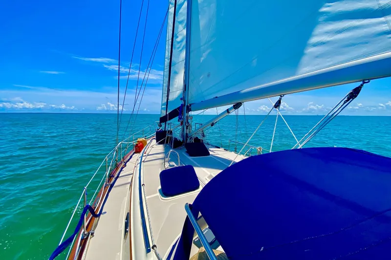 Slide: The Image of Sailing on a 2006 Island Packet 440 yacht under clear blue skies and calm seas. - 6