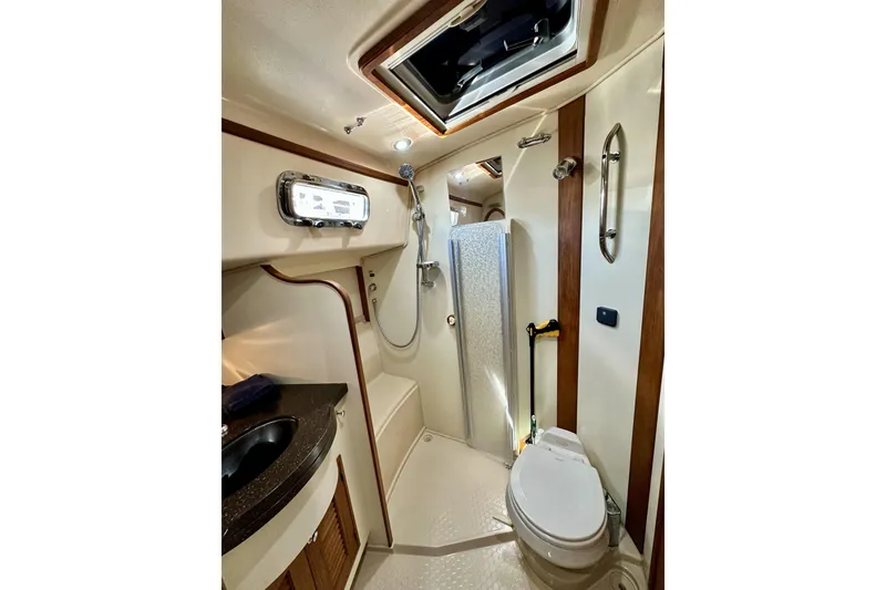 Slide: The Image of Luxurious 2006 Island Packet 440 yacht bathroom with shower, sink, and toilet. - 52