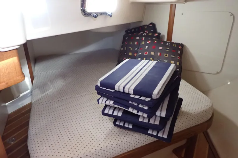 Slide: The Image of Interior cabin of 2006 Island Packet 440 yacht with striped cushions and nautical pillows. - 58
