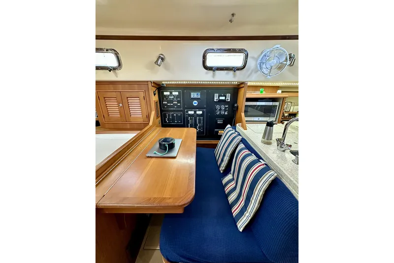 Slide: The Image of Interior of 2006 Island Packet 440 yacht with navigation station and cozy seating area. - 41