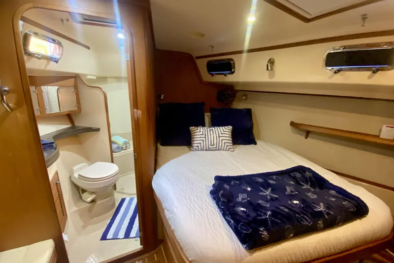 Slide: The Image of Luxurious 2006 Island Packet 440 yacht cabin with cozy bed and private bathroom. - 46