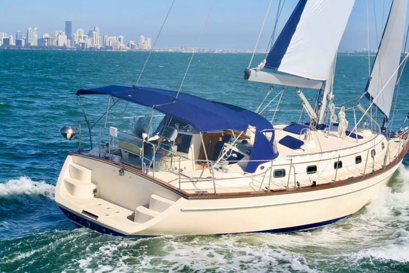 Slide: The Image of Sailing yacht Island Packet 440, 2006 model, cruising near a city skyline. - 3