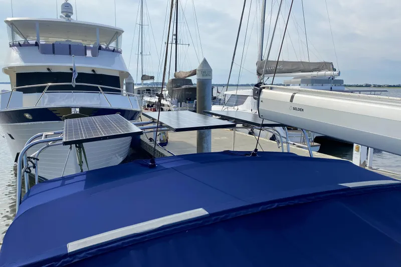 Slide: The Image of Docked 2006 Island Packet 440 sailboat with solar panels and blue canopy. - 16