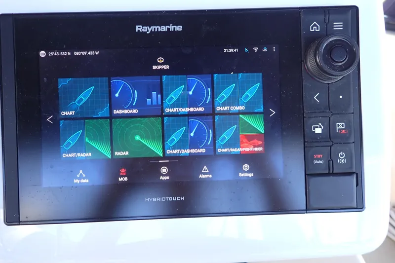 Slide: The Image of Raymarine HybridTouch navigation display on 2006 Island Packet 440 sailboat, showing chart and radar options. - 32
