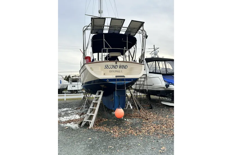 Slide: The Image of Island Packet 440 sailboat from 2006, named "Second Wind," on dry dock. - 14