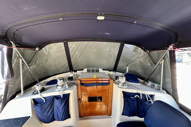 Slide: The Image of 2006 Island Packet 440 cockpit with navy canopy and wooden hatch. - 27