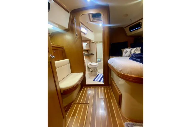 Slide: The Image of Interior of 2006 Island Packet 440 yacht, featuring cozy cabin and bathroom. - 48