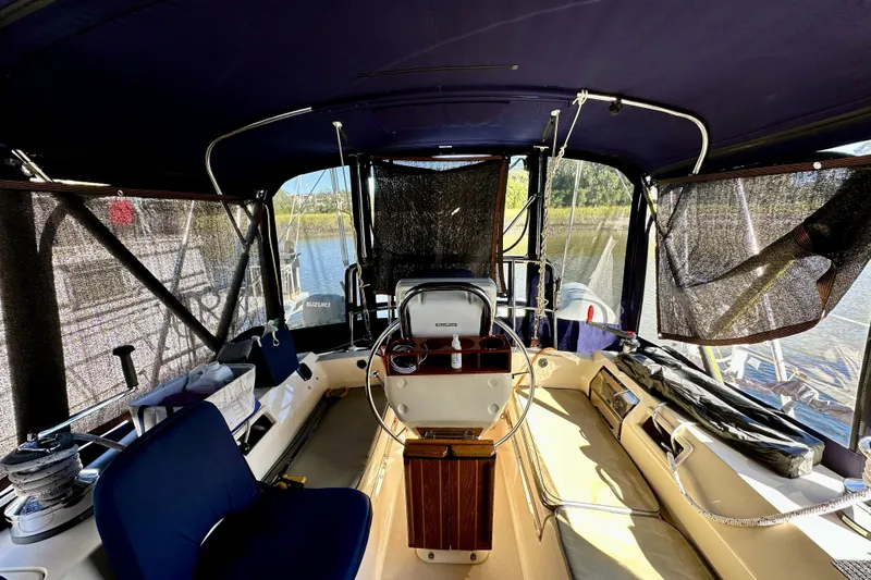 Slide: The Image of Interior view of 2006 Island Packet 440 sailboat cockpit with helm and seating. - 26