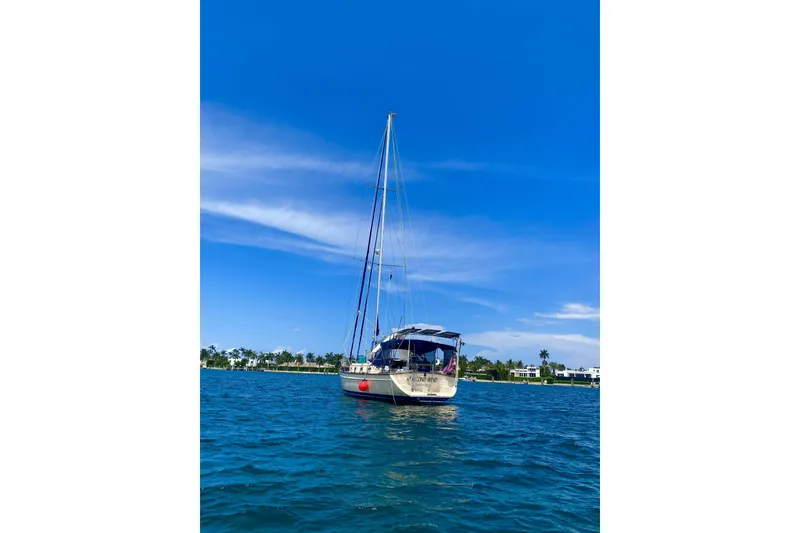 Slide: The Image of Sailboat Island Packet 440, 2006 model, anchored on a sunny day with clear blue skies. - 17