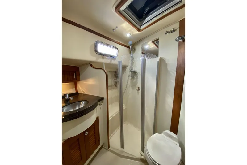 Slide: The Image of Bathroom interior of 2006 Island Packet 440 yacht, featuring shower, sink, and toilet. - 54