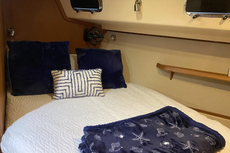 Slide: The Image of Cozy cabin interior of 2006 Island Packet 440 yacht with plush bedding and nautical decor. - 56