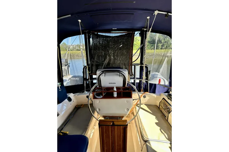 Slide: The Image of Cockpit of 2006 Island Packet 440 sailboat with steering wheel and seating. - 25