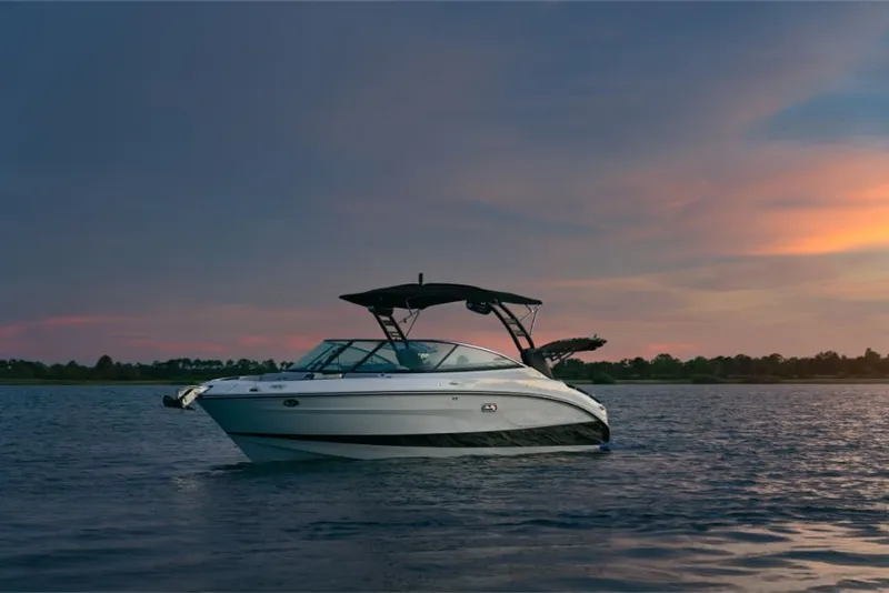 Slide: The Image of A sleek 2026 Sea Ray SLX 260 Surf boat floats on calm water at sunset. - 3
