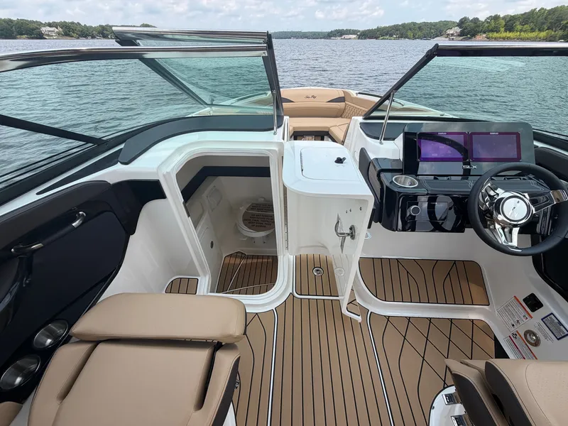 Slide: The Image of The image shows the cockpit of a 2026 Sea Ray SLX 260 Surf with modern instruments and comfortable seating. - 29