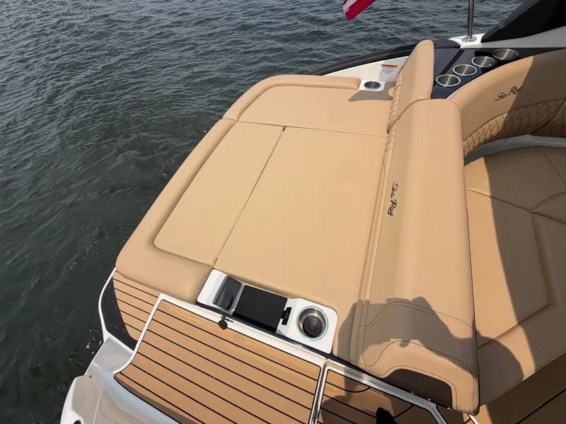 Slide: The Image of The image shows the stern of a 2026 Sea Ray SLX 260 Surf boat with beige upholstery. - 33