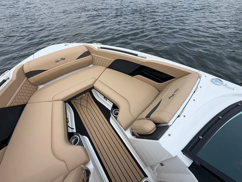 Slide: The Image of The image shows the bow area of a Sea Ray SLX 260 Surf boat with beige upholstery. - 19