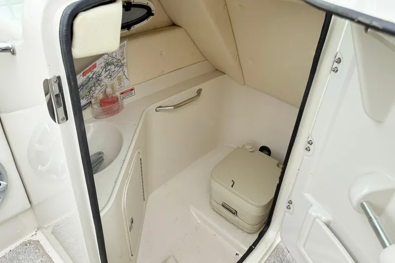 Slide: The Image of 2007 Sea Ray 260 Sundeck interior with compact marine toilet and sink. - 16