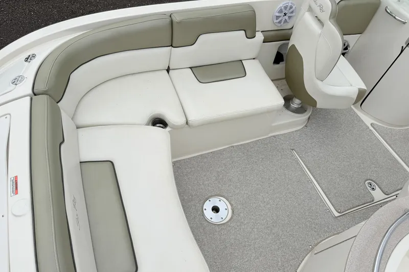 Slide: The Image of 2007 Sea Ray 260 Sundeck interior with beige seating and carpeted flooring. - 4
