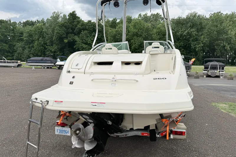 Slide: The Image of 2007 Sea Ray 260 Sundeck boat, rear view, parked on a trailer in a lot. - 12