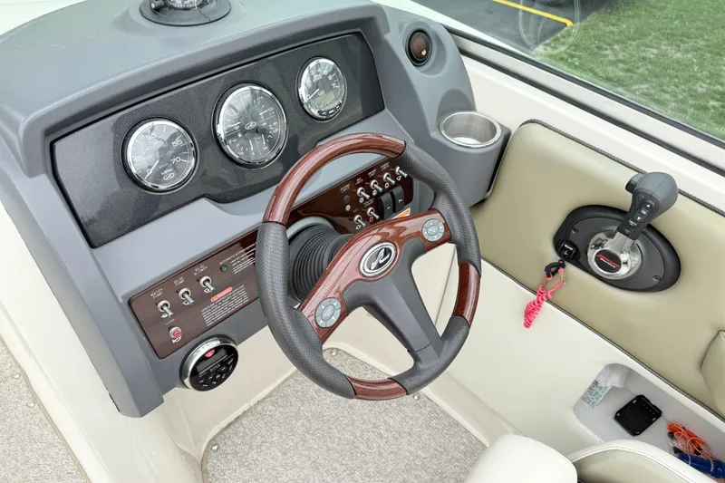 Slide: The Image of 2007 Sea Ray 260 Sundeck dashboard with steering wheel, gauges, and controls. - 18