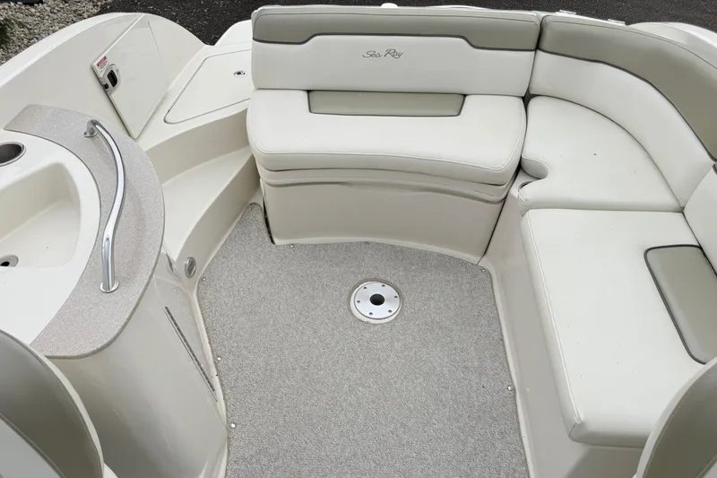 Slide: The Image of 2007 Sea Ray 260 Sundeck interior with white seating and carpeted floor. - 20
