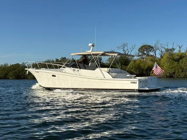 Slide: The Image of A white boat cruising on calm water, with an American flag at the stern. - 3