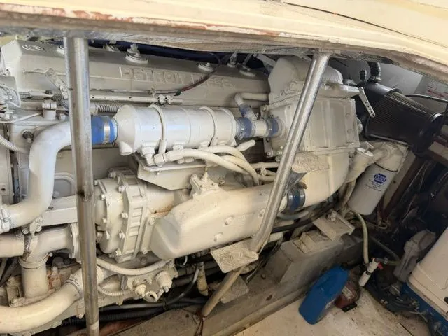 Slide: The Image of Engine compartment of a 1990 Topaz Royale with visible engine and pipes. - 12