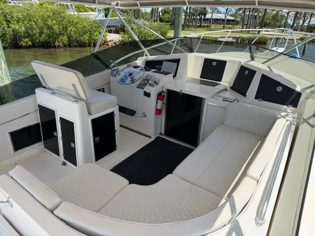 Slide: The Image of The boat features a spacious cockpit with white upholstery and a helm station. - 5
