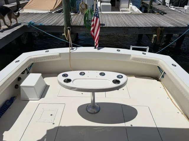 Slide: The Image of The image shows the stern of a boat with a fishing station and an American flag. - 7