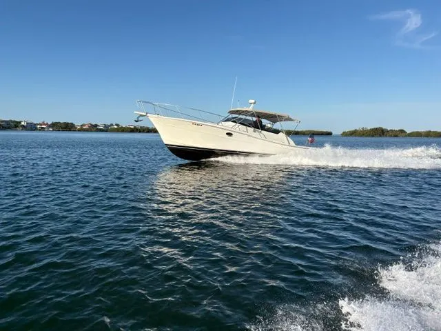 Slide: The Image of A 1990 Topaz Royale cruising swiftly on the water under a clear sky. - 2