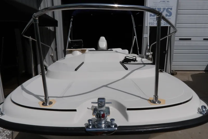 Slide: The Image of 1978 Boston Whaler 21 Revenge boat, docked, showcasing deck and railing. - 3
