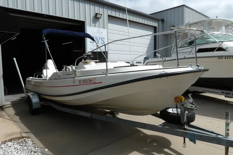 Slide: The Image of 1978 Boston Whaler 21 Revenge boat on trailer outside storage facility. - 2
