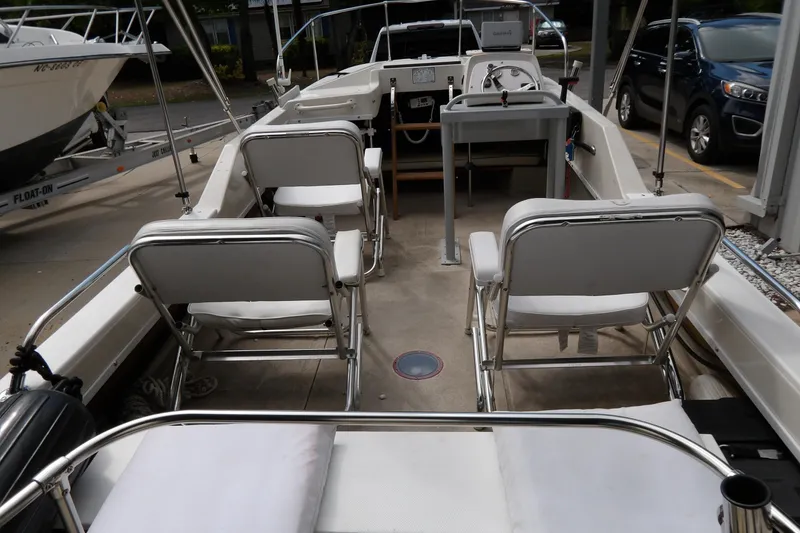 Slide: The Image of 1978 Boston Whaler 21 Revenge boat interior with seating and steering console. - 10
