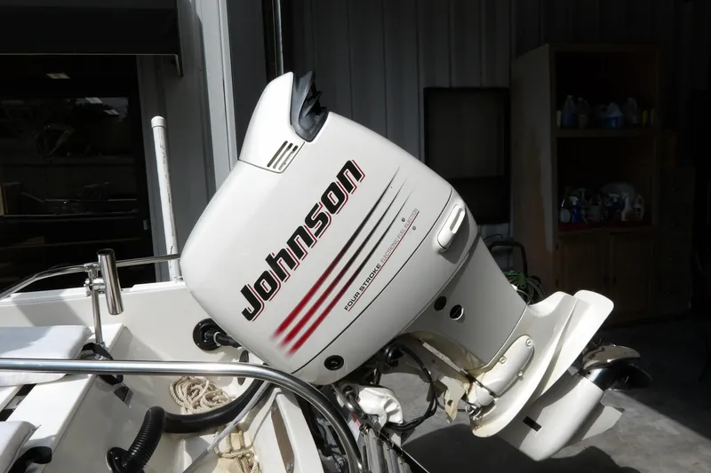 Slide: The Image of 1978 Boston Whaler 21 Revenge with Johnson outboard motor in a garage setting. - 6