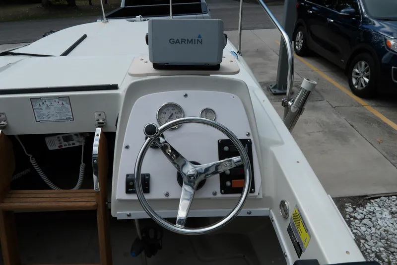 Slide: The Image of 1978 Boston Whaler 21 Revenge boat dashboard with Garmin GPS and steering wheel. - 11
