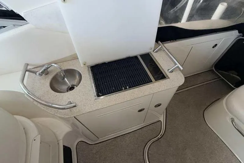 Slide: The Image of The 2011 Sea Ray Sundancer 370 features a compact outdoor kitchen with a sink and grill. - 12