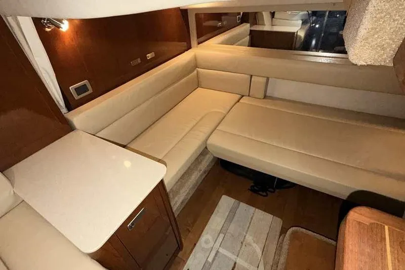 Slide: The Image of Luxurious interior of 2011 Sea Ray Sundancer 370 yacht with beige seating and wooden accents. - 27
