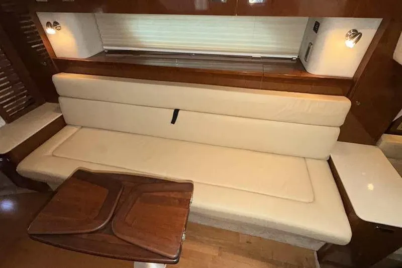 Slide: The Image of Interior of 2011 Sea Ray Sundancer 370 with beige seating and wooden table. - 26