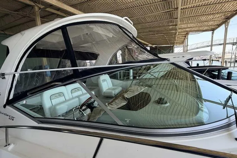 Slide: The Image of 2011 Sea Ray Sundancer 370 yacht docked under a covered marina. - 2