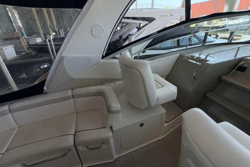 Slide: The Image of Interior of 2011 Sea Ray Sundancer 370 yacht with white seating and helm area. - 13