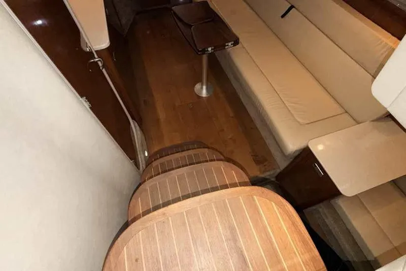 Slide: The Image of Interior of 2011 Sea Ray Sundancer 370 yacht with wooden steps and beige seating. - 20
