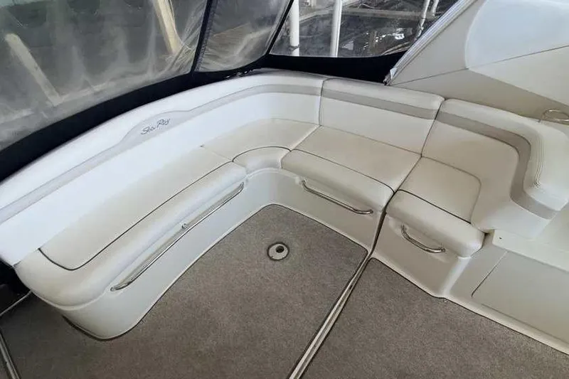 Slide: The Image of Luxurious seating area on a 2011 Sea Ray Sundancer 370 yacht, featuring plush white upholstery. - 10