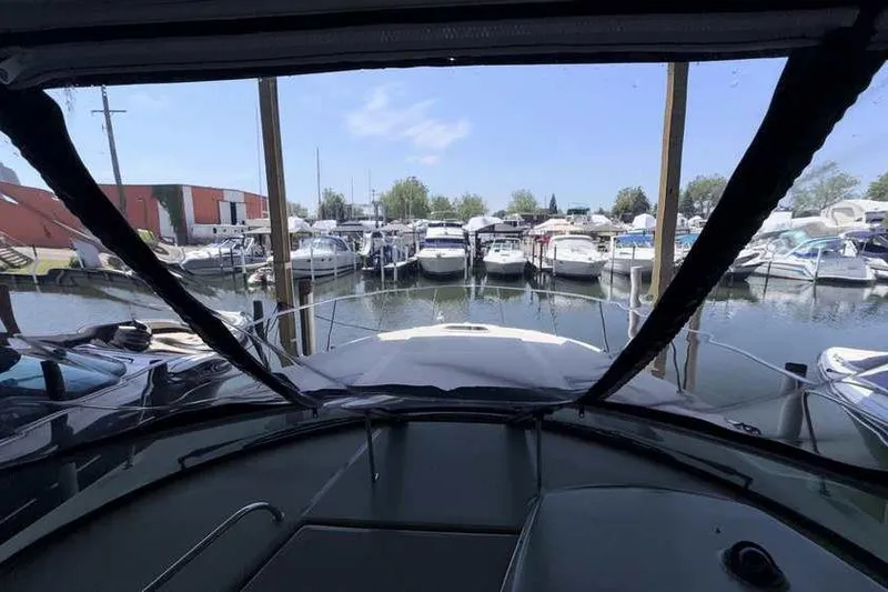 Slide: The Image of View from a 2011 Sea Ray Sundancer 370, overlooking a marina with multiple boats docked. - 15