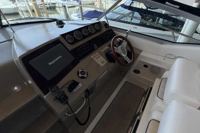 Slide: The Image of Cockpit of 2011 Sea Ray Sundancer 370 with steering wheel and navigation equipment. - 16