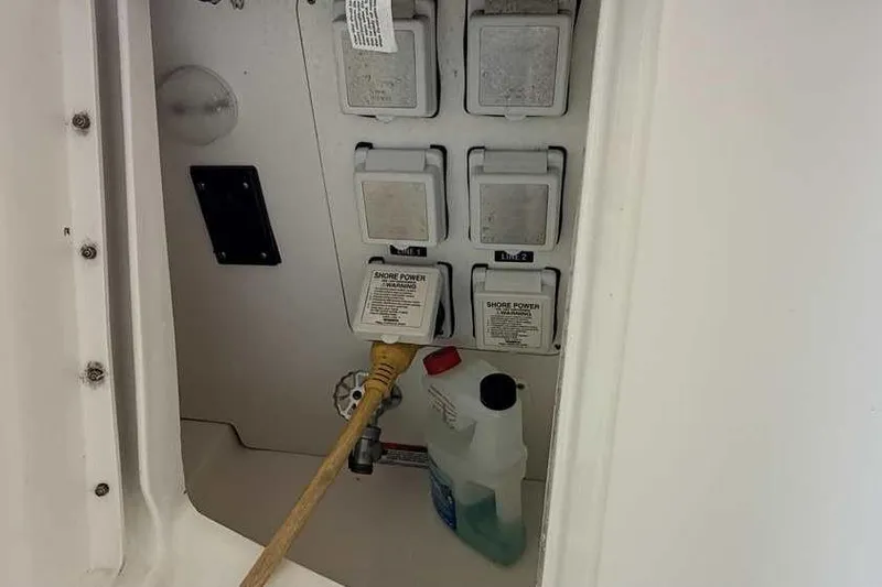 Slide: The Image of Electrical panel with shore power connections on a 2011 Sea Ray Sundancer 370 boat. - 7