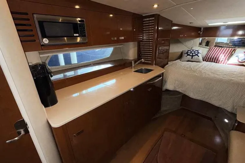 Slide: The Image of Interior of 2011 Sea Ray Sundancer 370 yacht with kitchenette and cozy sleeping area. - 22