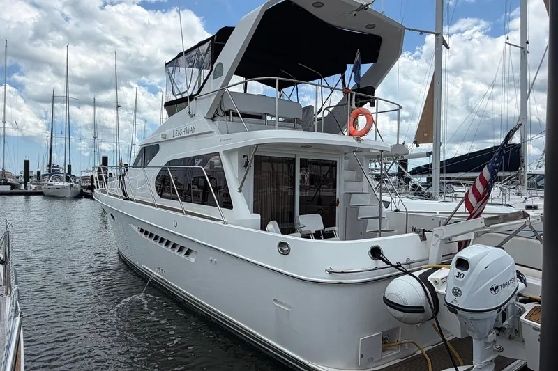 Slide: The Image of 2005 Ocean Alexander 48 Altus yacht docked at marina under cloudy sky. - 8