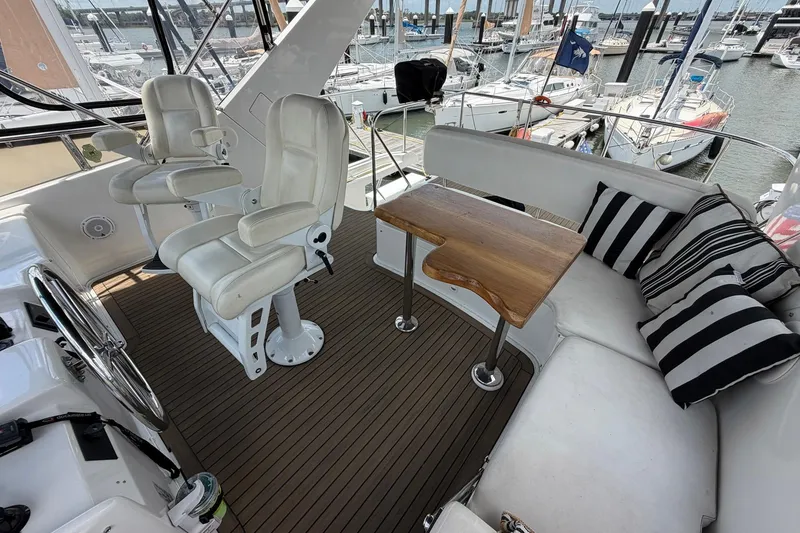 Slide: The Image of Luxurious 2005 Ocean Alexander 48 Altus yacht interior with seating and helm chairs. - 28