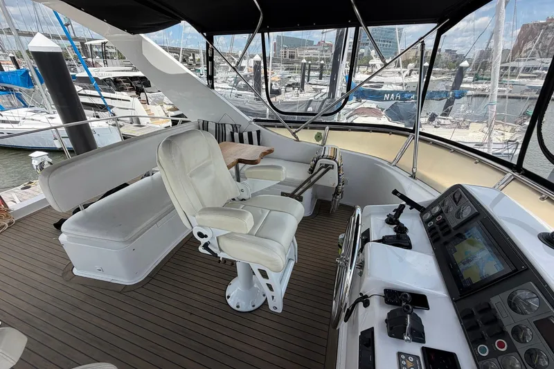 Slide: The Image of Flybridge of 2005 Ocean Alexander 48 Altus yacht with helm station and seating area. - 29
