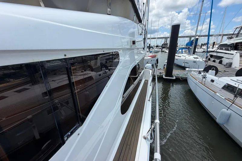 Slide: The Image of 2005 Ocean Alexander 48 Altus yacht docked in a marina, surrounded by other boats. - 22
